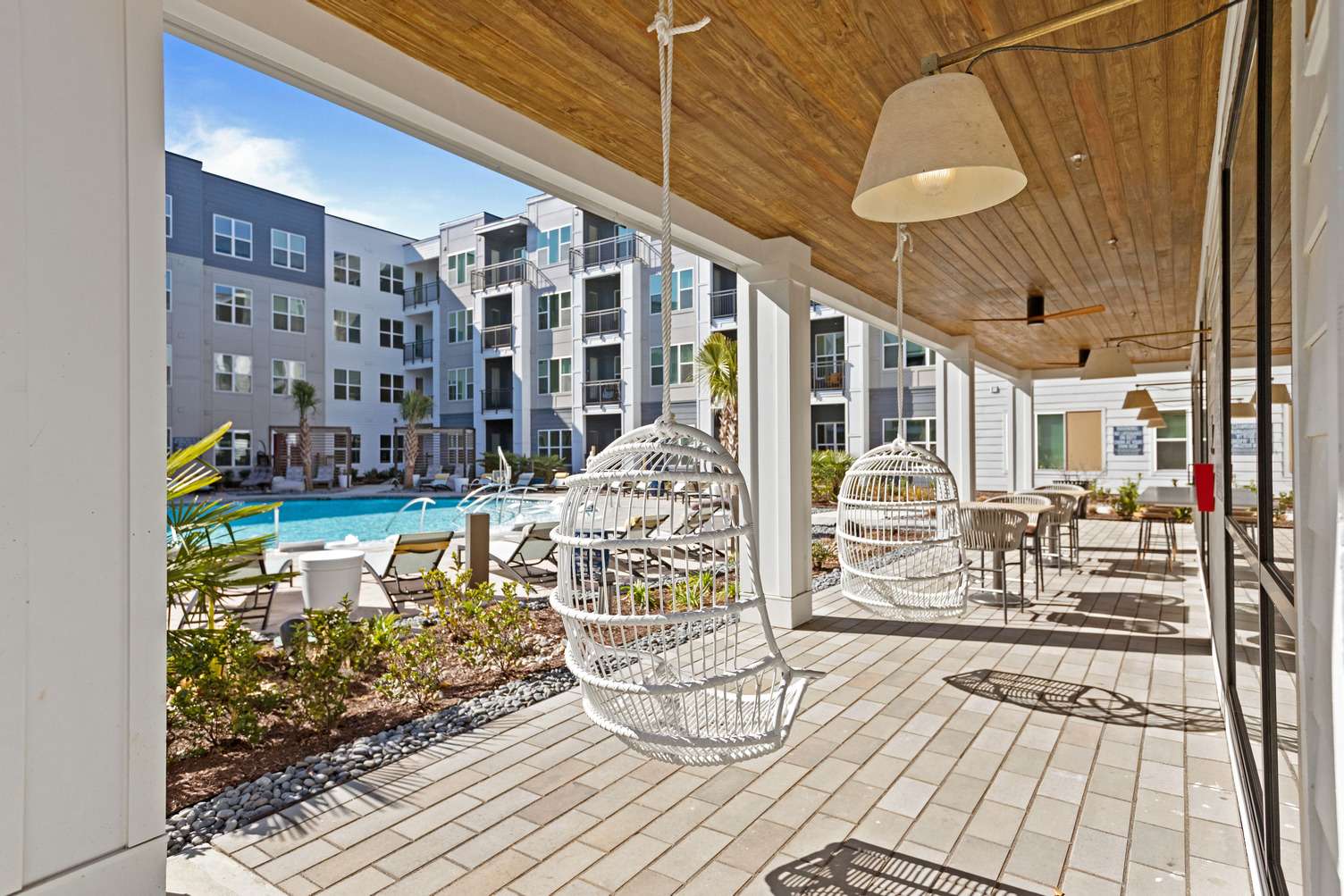 Unwind by the pool after work in a peaceful setting. Relaxing poolside lounge area at a furnished corporate housing community in NC.